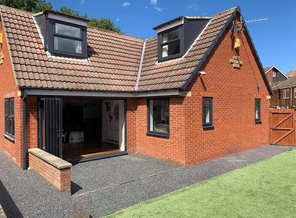 Anthracite grey fascias and soffits on a dormer bungalow with bifold doors