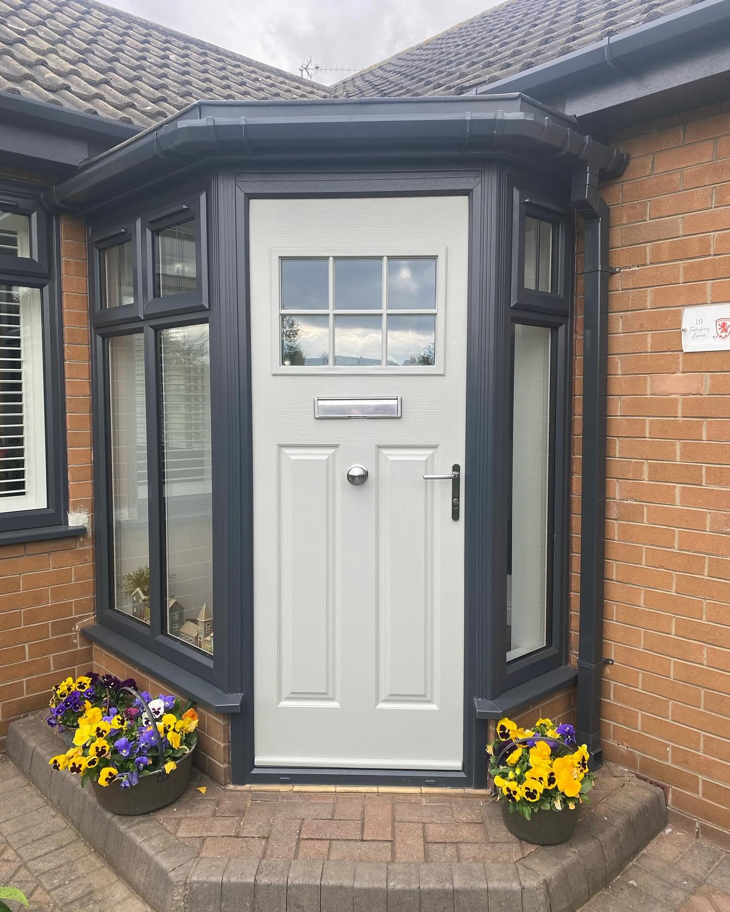Anthracite grey roofline wrapping around a porch with composite door
