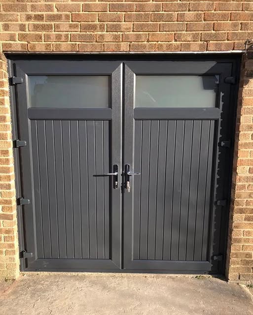 Anthracite grey side hinged garage doors with glazed top panels on a brick home in middlesbrough