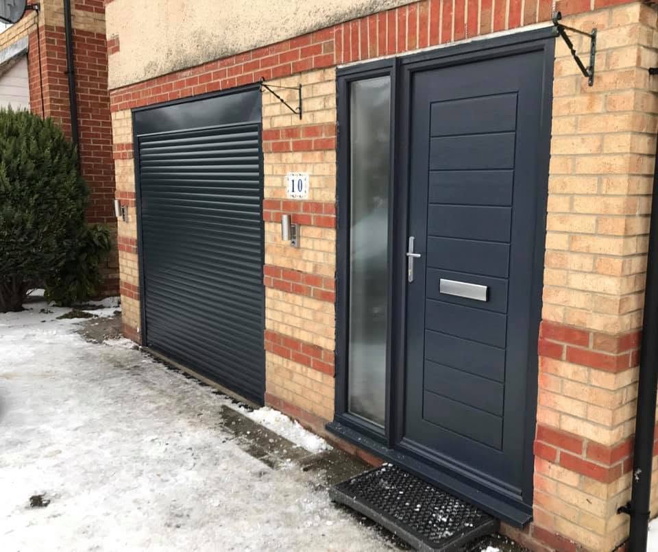 Anthracite grey single roller garage door on a brick home