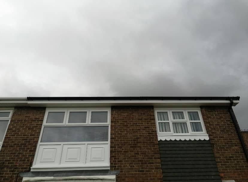 Black replacement fascias and guttering along a roofline