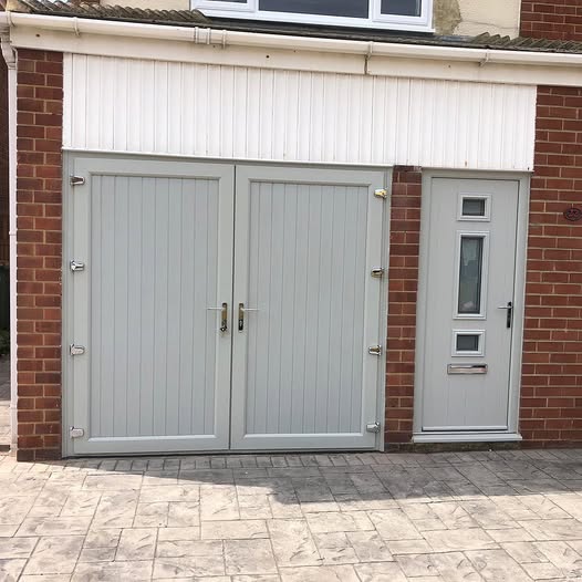 Light grey side hinged garage doors beside a matching composite door on a brick home in teesside