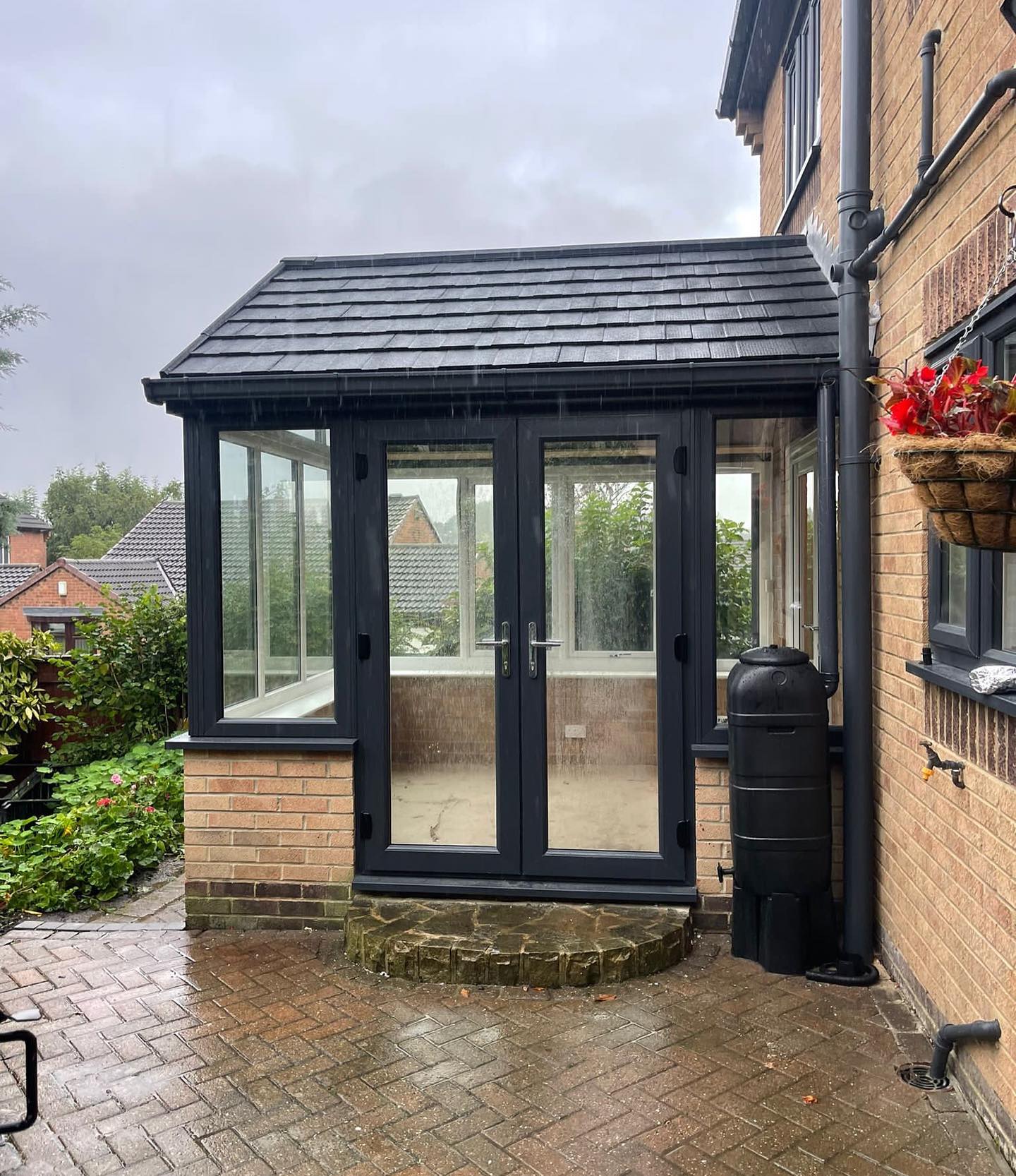 Conservatory with an anthracite warm roof and french doors installed by endeavour windows
