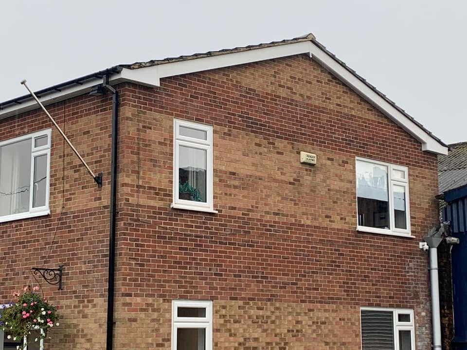 White upvc fascias, soffits and guttering on a brick gable end